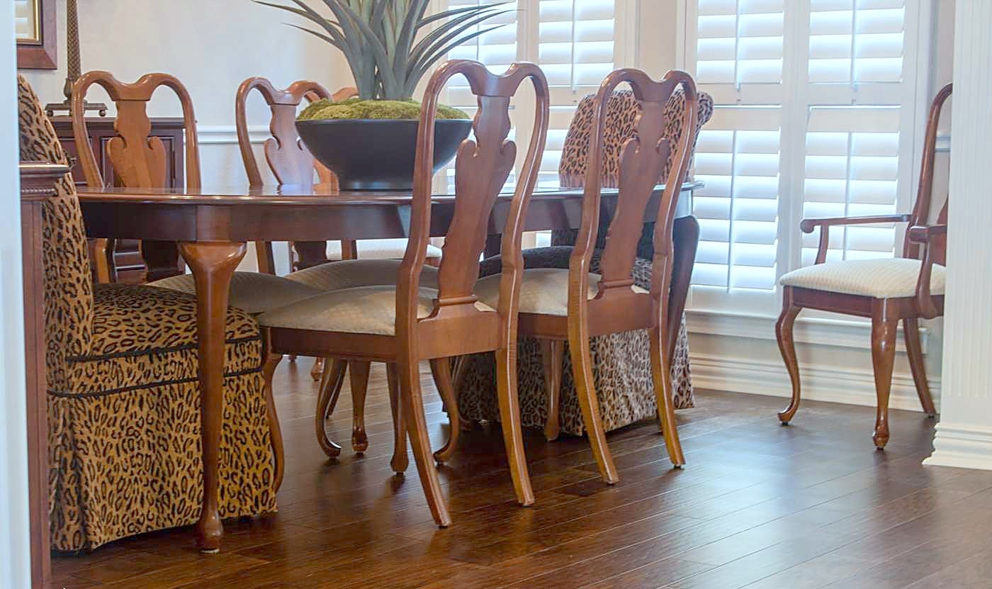 Wood-look plank flooring under a dining table and chairs