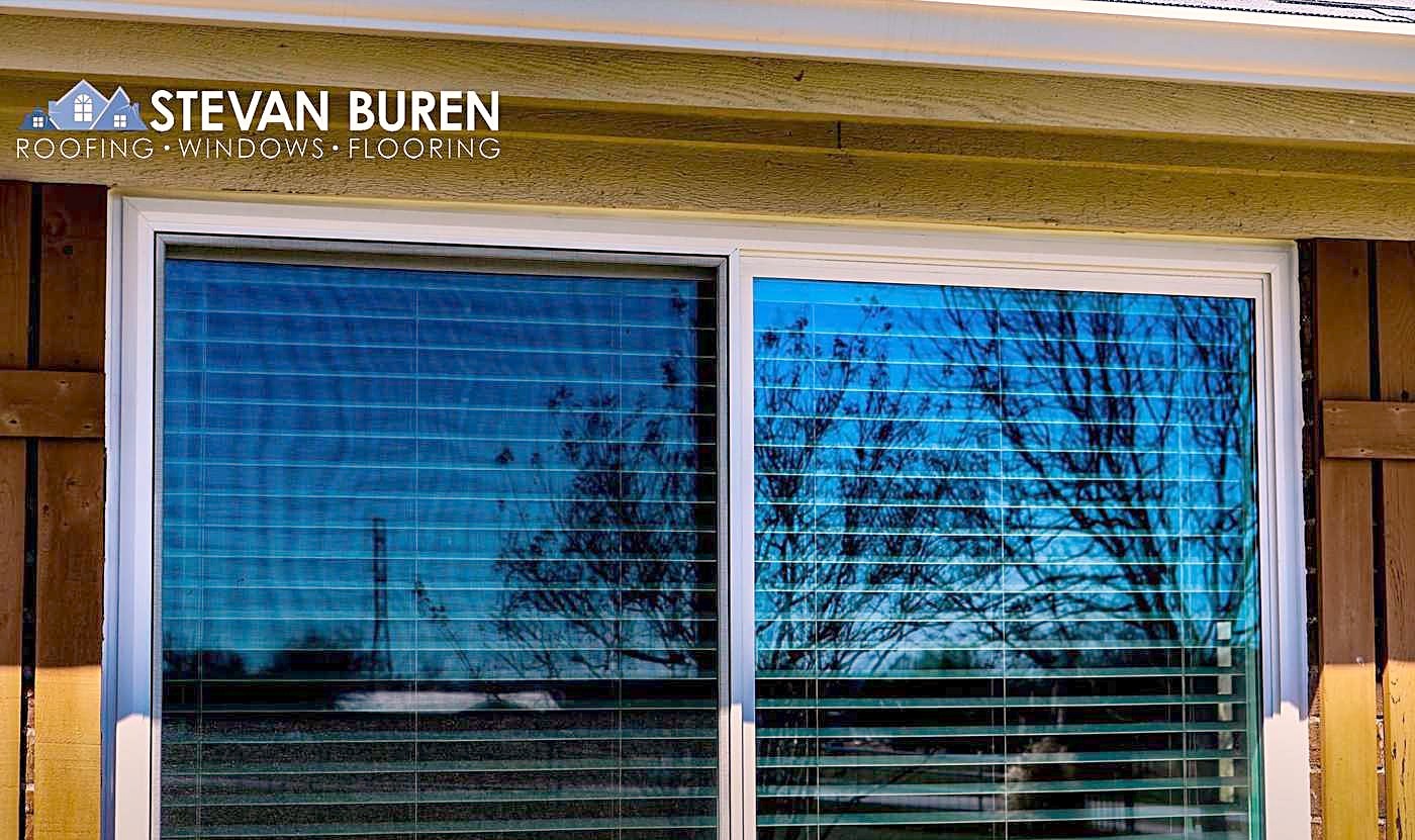 A new sliding glass door with blinds between the panes